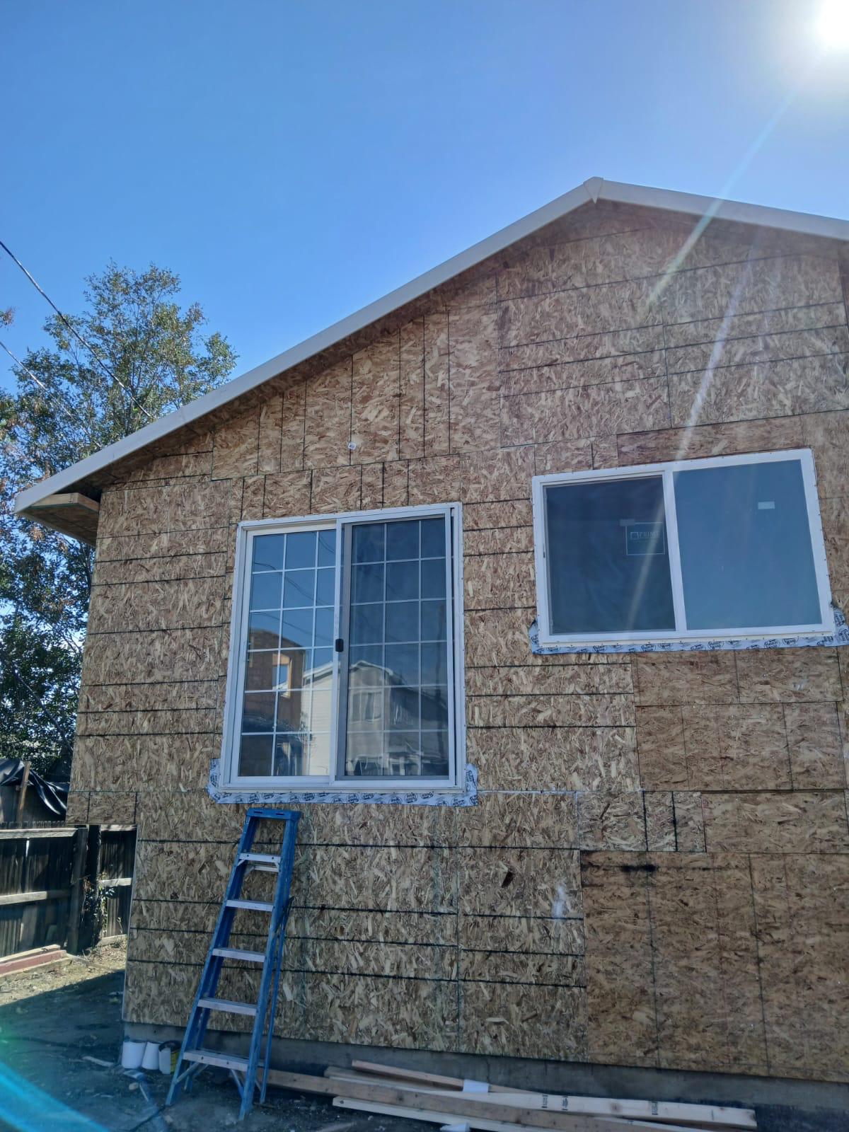 Restored home exterior with new OSB sheathing and windows — Force Construction Inc.